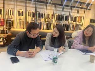 A group of people sitting at a table

Description automatically generated